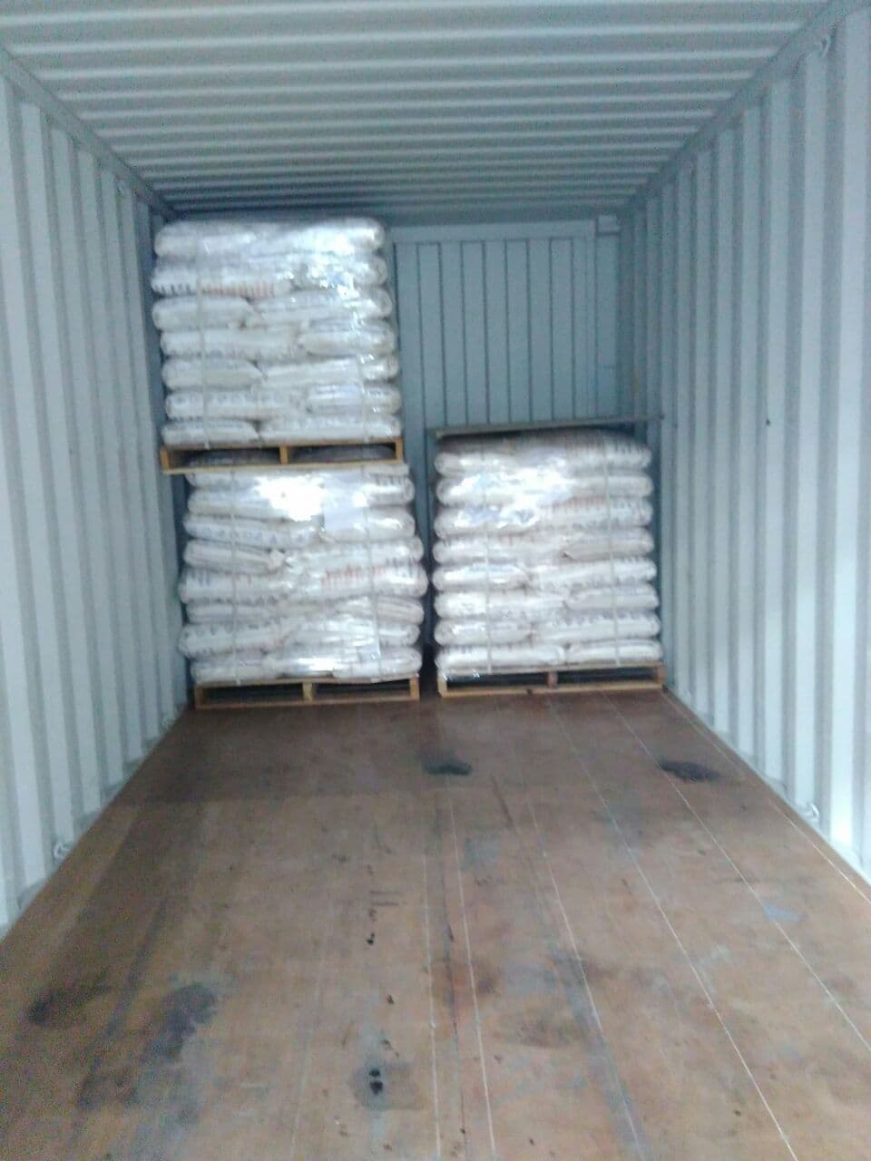 Pallets of bags loaded inside a shipping container
